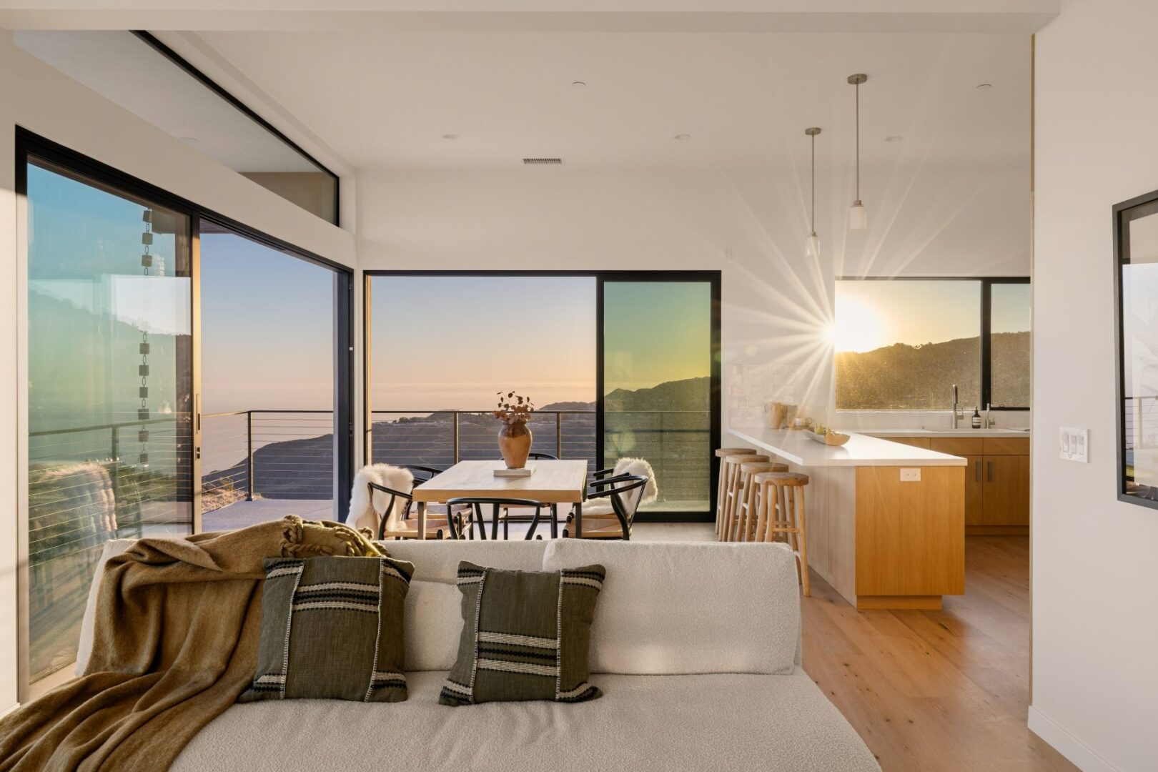 Dining area with a table set for meals and a view of the kitchen.
