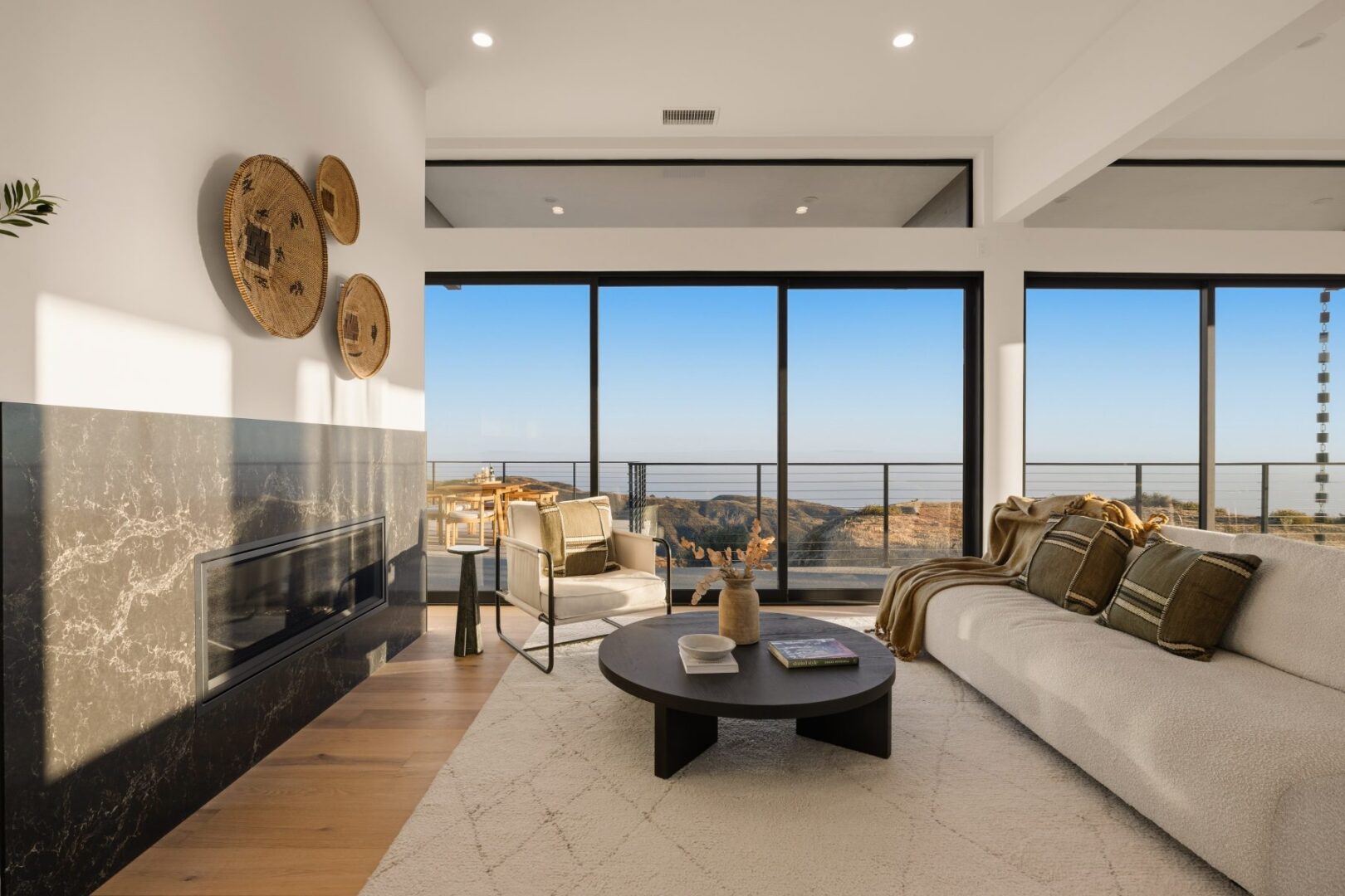Spacious living room with large windows and modern decor.