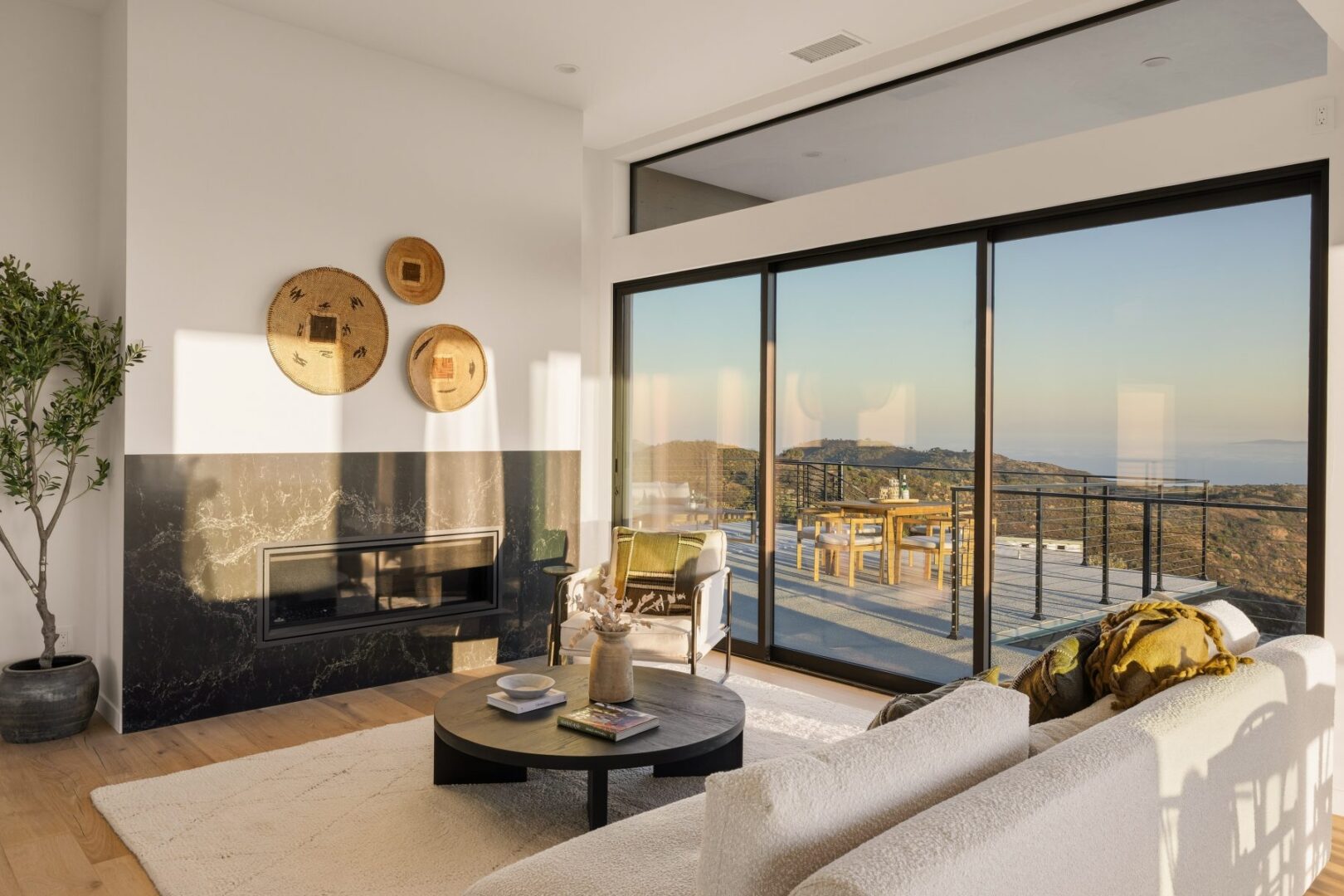 Cozy living room with a view and modern decor, sunlight streaming in.