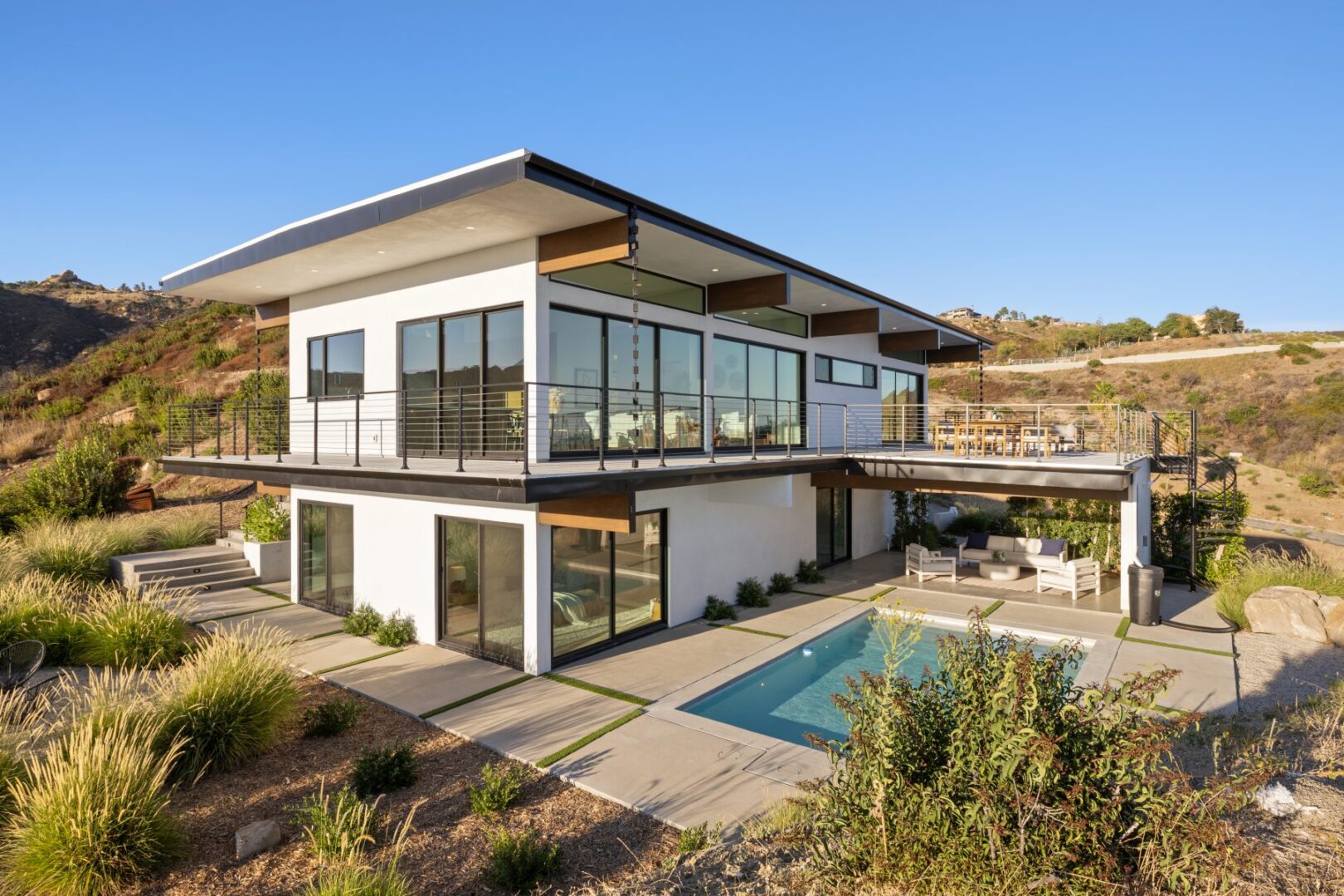 Exterior view of the house showcasing multiple levels and a pool area.